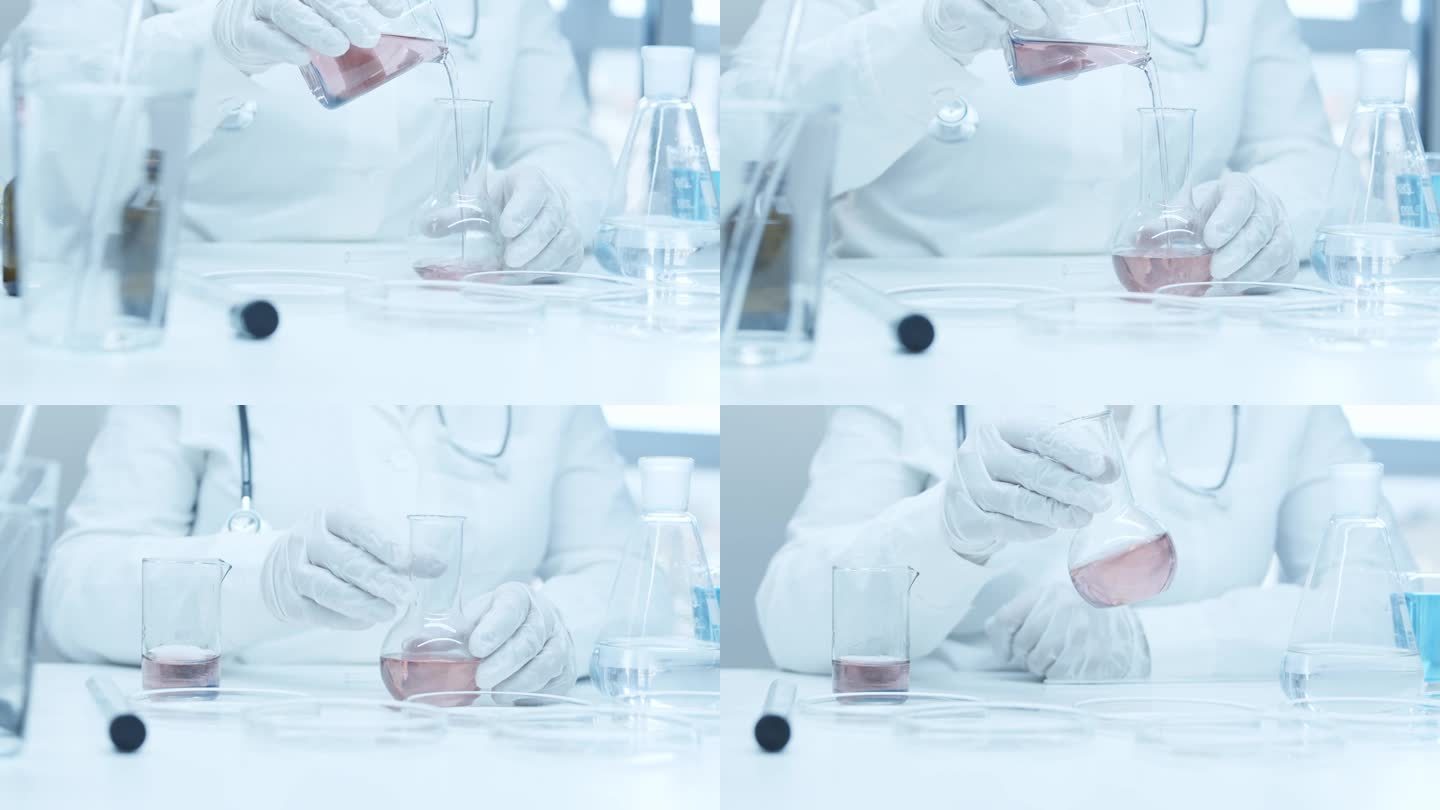 戴着医用手套的实验室助理的手。将试剂倒入试管中。