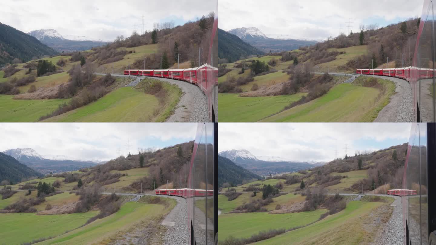 红色列车通过瑞士Landwasser高架桥。从窗户拍的。