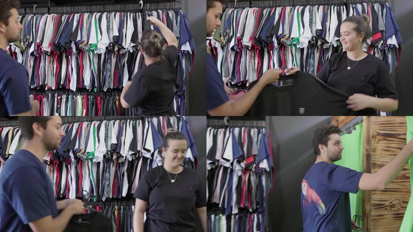 店员在商店里帮助一个年轻人浏览衣服