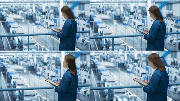 年轻的亚洲女工程师站在电子工厂的工作台上使用平板电脑。机器正在进行维护，专家通过在线软件监控进度