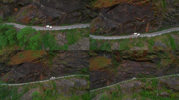 从空中俯瞰，白色四轮驱动车辆在山路上缓慢上坡。喜马拉雅山周围的公路旅行。安纳普尔纳环行。独特的管理理