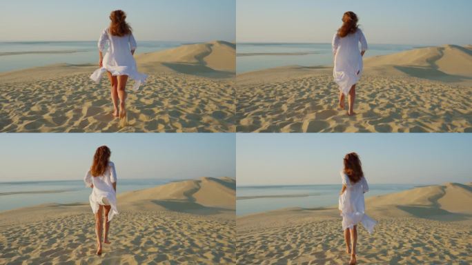 美丽的高个子女人跑着长长的美丽的白色衣服在风中飘动，夕阳由风景秀丽的沙漠自然景观
