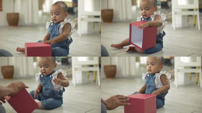 可爱的小非洲女孩玩和打开盒子