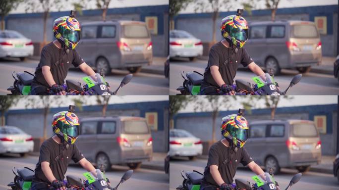 骑摩托车男子等红绿灯