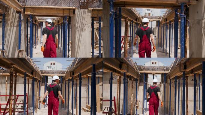 以下是专业建筑工人戴安全帽手持平板电脑的背影。施工人员在建筑工地的整体框架结构之间走动，检查水平模板