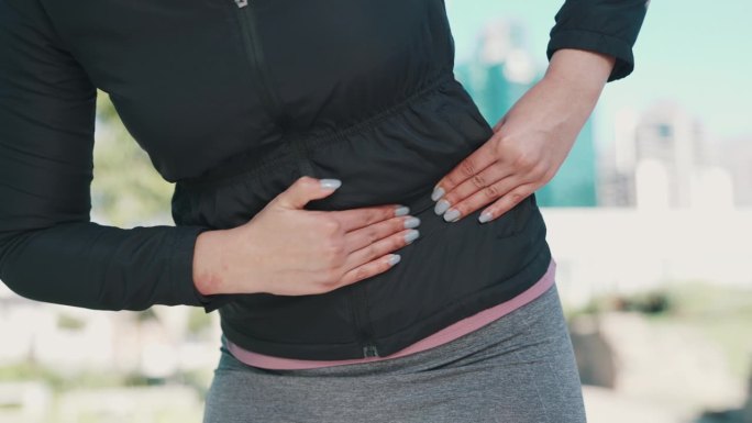 腹部抽筋和肌肉损伤的女性手部的胃、疼痛和户外健身。运动，训练和健康问题从跑步的女性按摩健康和瘀伤的问