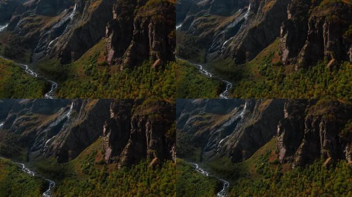 空中全景的山谷与河流附近的山在秋天的一天，从空中看雄伟的岩石