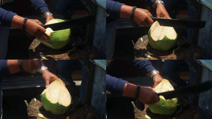 一个卖饮料的人正在切椰子