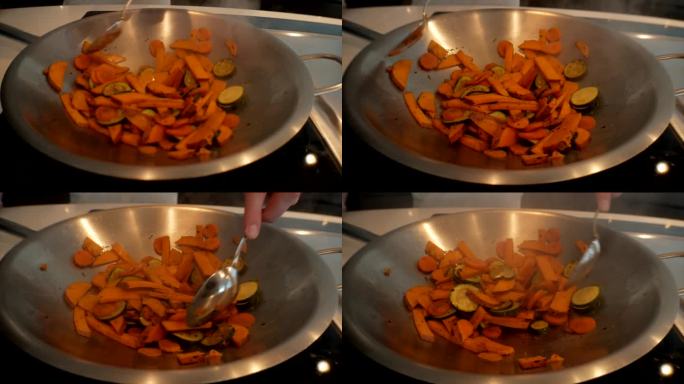 4k摄像机镜头。烹饪蔬菜。在家健康饮食。煮胡萝卜、西葫芦和红薯。