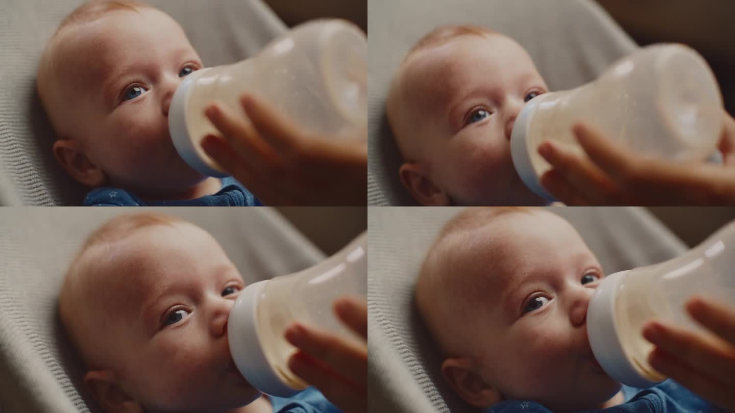 小男孩在家里用妈妈喂的奶瓶喝牛奶的特写