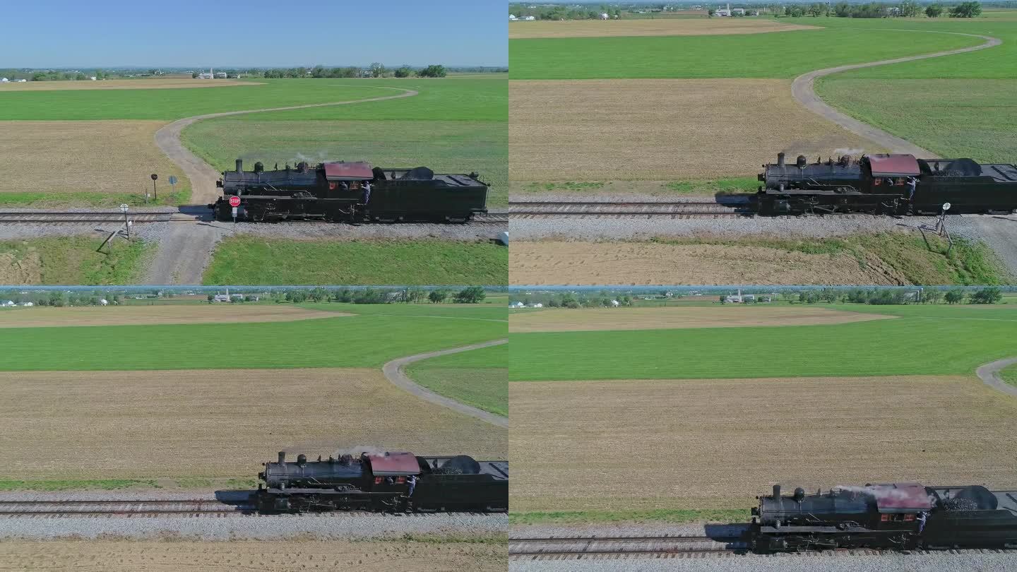 一架蒸汽机车在乡间的慢动作测试中自行行驶的无人机视图