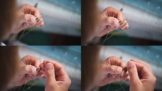 一个孩子正在勤奋地制作精致的珠饰，全神贯注地编织复杂的装饰品。双手热情地工作，创造出小小的杰作。
