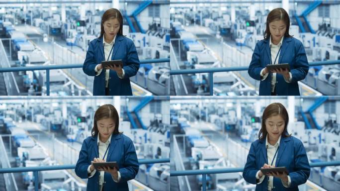 一个美丽的日本工程师的肖像使用平板电脑和环顾工厂设施的设备生产现代电子元件的不同行业