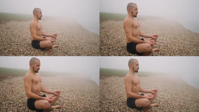 雾天湖岸，光膀子的年轻人莲花坐姿冥想的侧视图