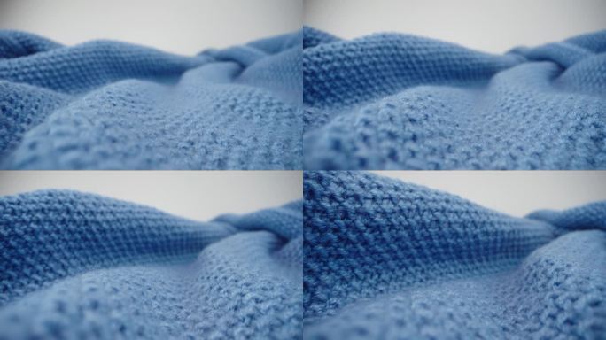 微距摄影小车拍摄蓝色针织面料的质感，滑块特写针织服装的羊毛纺织品，细部保暖围巾或毛衣，表面有质感