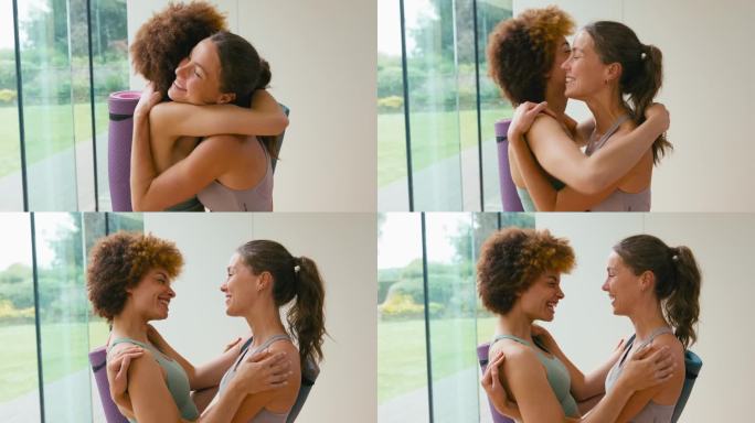两个穿着运动服的女性朋友在健身房或瑜伽馆见面并拥抱