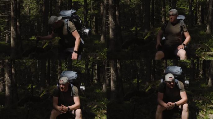 心烦意乱的成年男子背着徒步背包坐在森林里的石头上