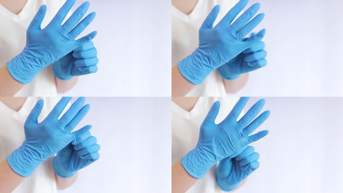 双手戴医用乳胶手套。医生或护士戴丁腈防护手套
