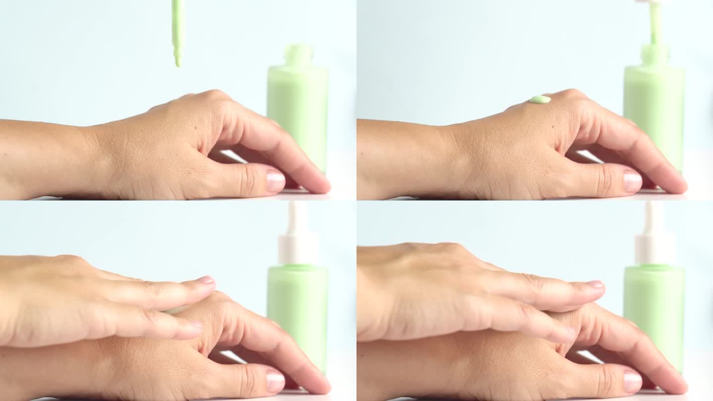 绿色保湿精华液滴在女人的手上，护肤化妆品。柔和绿色的精华液或凝胶从移液管滴在干燥的皮肤上。水疗中心的