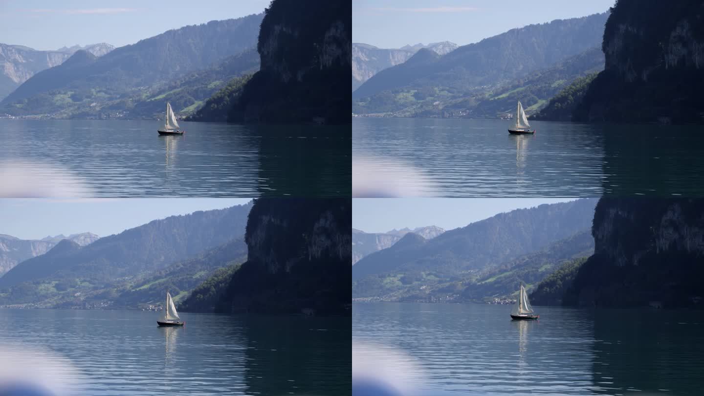 瓦伦湖上帆船的电影广角镜头，高山背景，慢镜头。瑞士Weesen