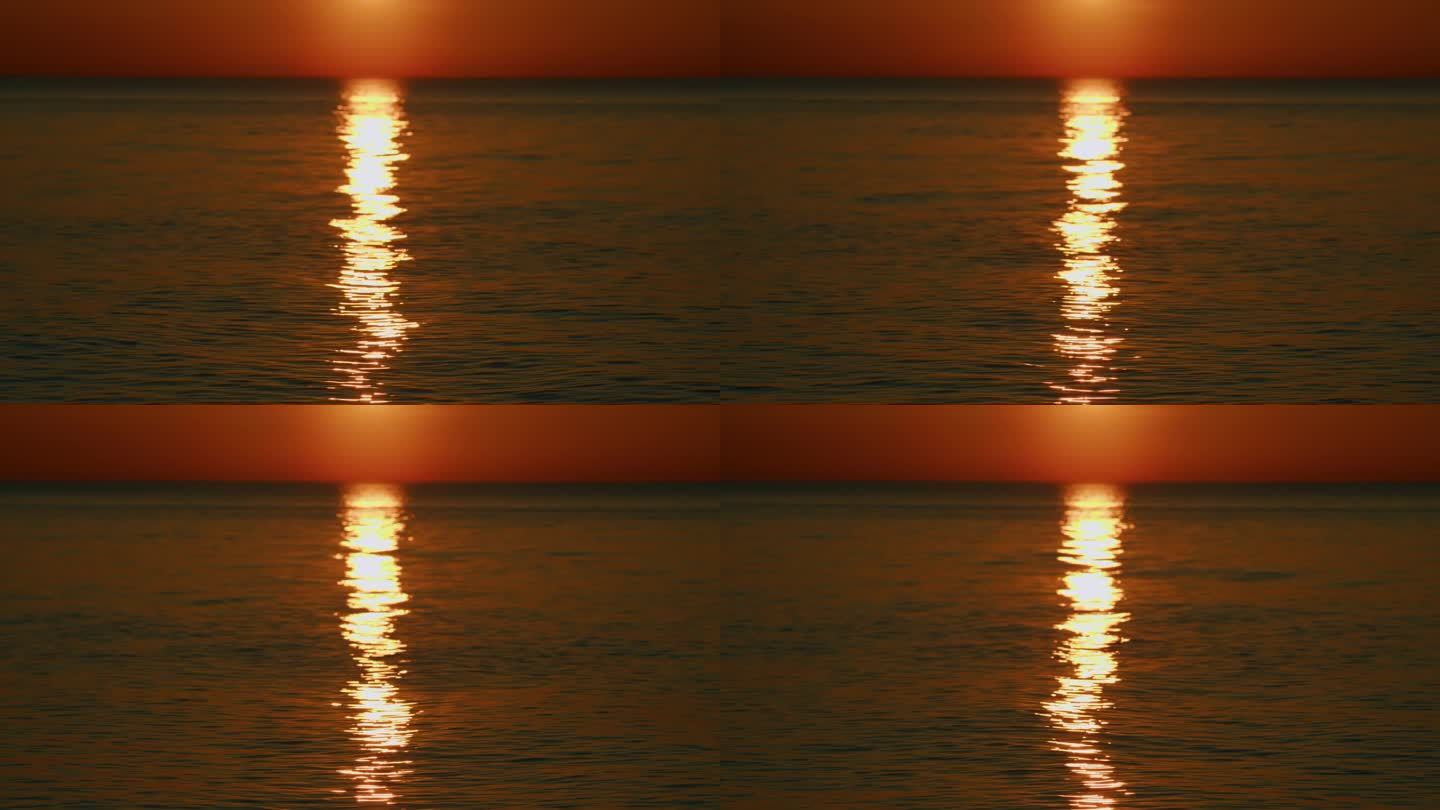 自然的概念。金色之光的海洋全景。太阳升起在海洋和红色的天空，看到海浪。缓慢的运动。