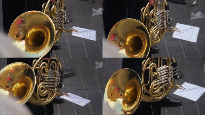在游行中演奏长号的音乐家，乐器和艺术家的手的特写。慢镜头拍摄。