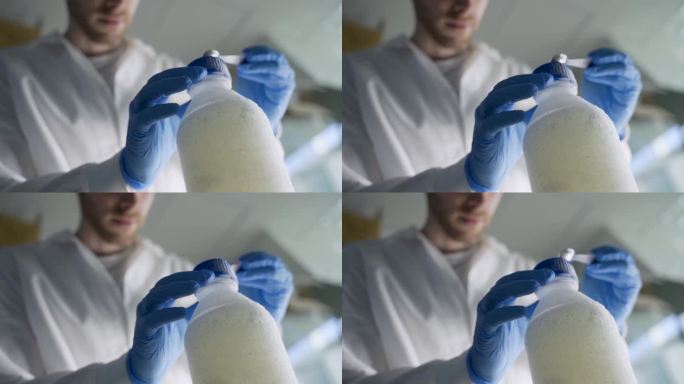 科学家或学生在实验室中清除冷冻实验室容器中的残留物