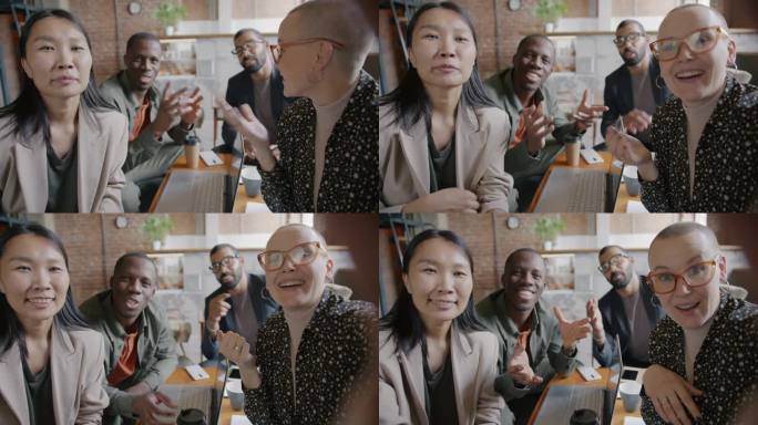 多元文化商业团队进行在线视频通话，鼓掌竖起大拇指，享受办公室的成功