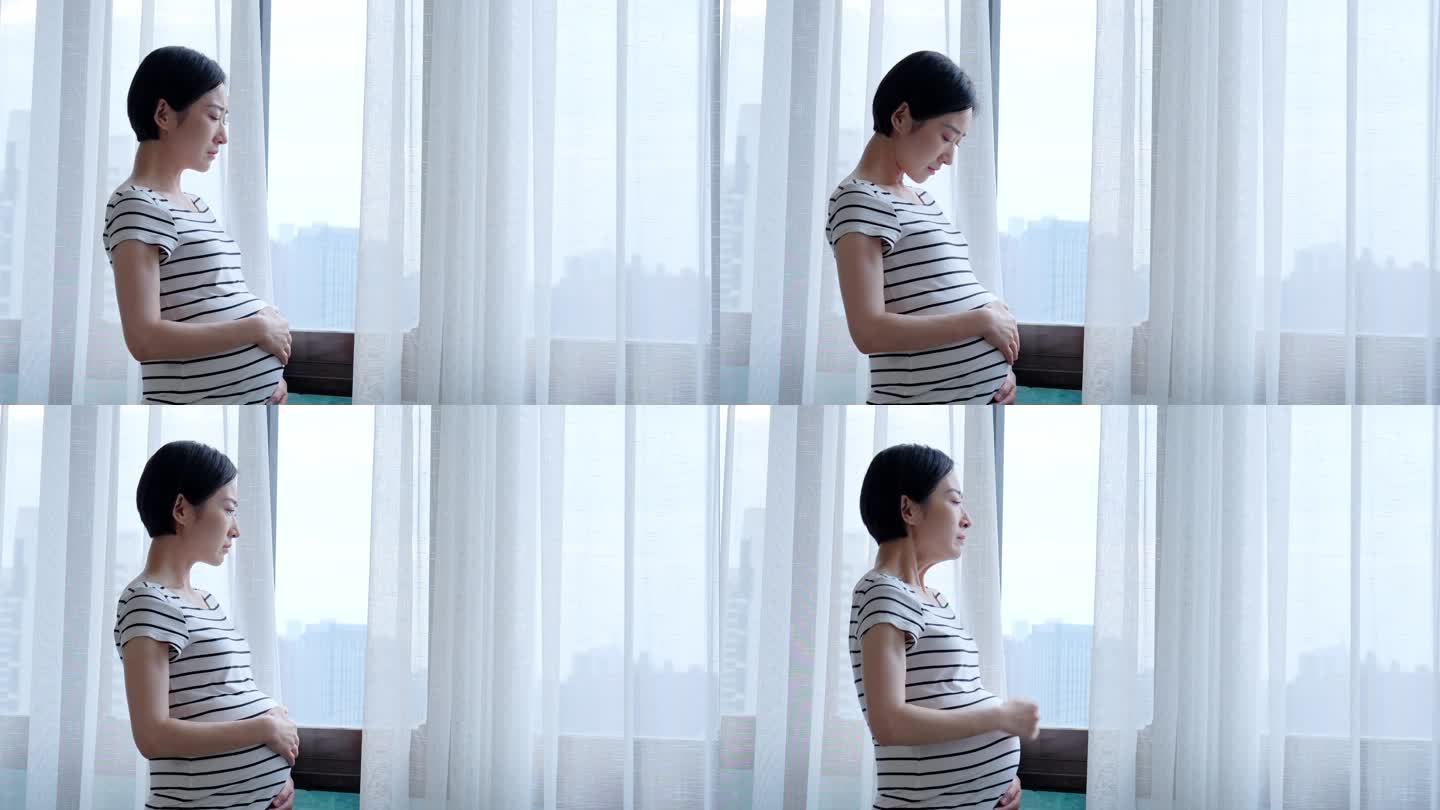 孕妇窗前伤感哭泣