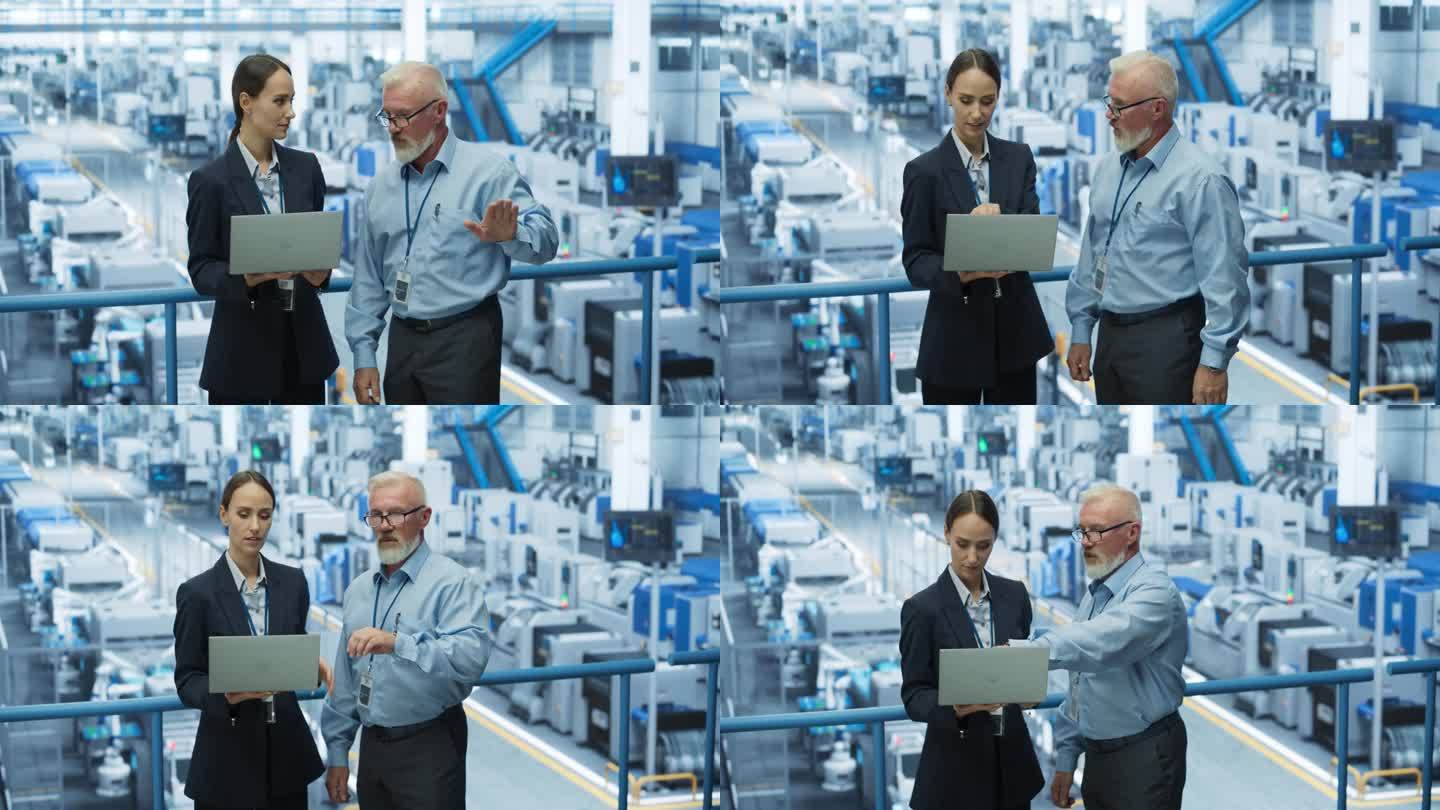 经验丰富的男女工程师站在现代工业工厂的平台上，使用笔记本电脑，讨论人工智能机器的现代电子产品生产