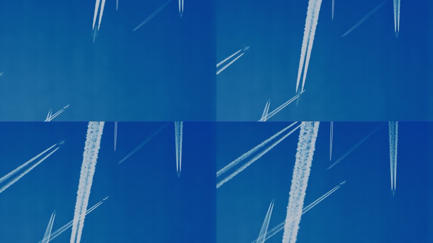 正下方的镜头是飞机在万里无云的蓝天上留下的水汽痕迹。在正下方，一张令人惊叹的照片捕捉到了飞机在万里无