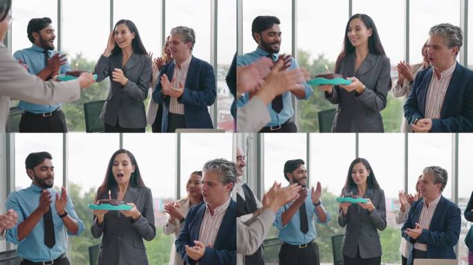 西班牙裔拉丁女经理吹灭生日蛋糕上的蜡烛，同事的惊喜让她感觉很好。一群同事为女经理制作惊喜生日蛋糕。团