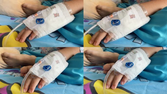 在医院里，一个孩子的手被注射生理盐水的针扎穿了。
