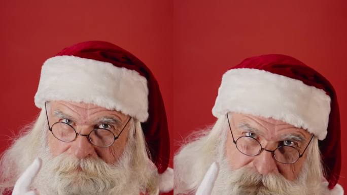 红色背景上皱着眉头的圣诞老人摇着手指