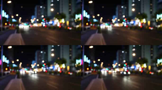 道路交通散焦，交通城市夜行。模糊的灯光散景汽车前灯行驶傍晚的城市道路。模糊的夜晚城市交通。汽车和公共
