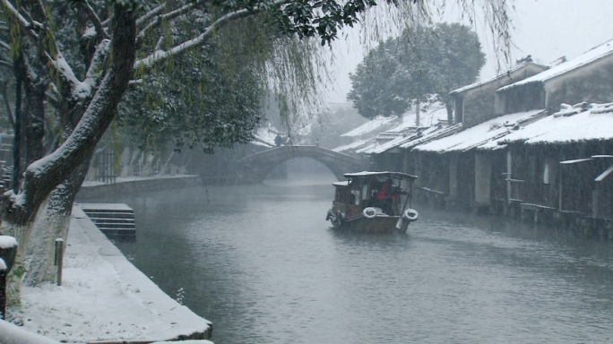 风雪中水上的摇橹船过桥雪景
