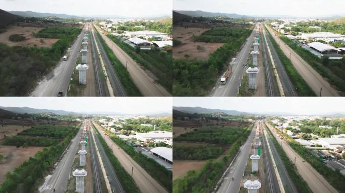 鸟瞰图:正在施工的大型快速轨道交通线路，在新建的高速公路或桥梁上，架设梁机和起重机一起工作。