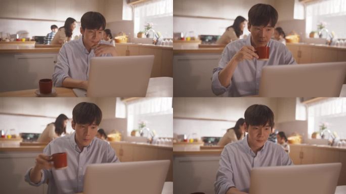 韩国家庭:年轻的父亲在等菜的时候用笔记本电脑远程工作，妻子和孩子在后台准备午餐。支持一个商人的家庭