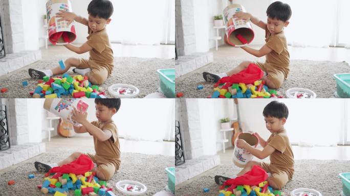 亚洲儿童在温暖的地板上玩木块