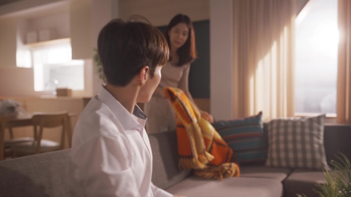 幸福的房主搬进来:可爱的韩国夫妇在他们舒适的新公寓里打开箱子，装饰他们的新家。抵押贷款，房地产，二口