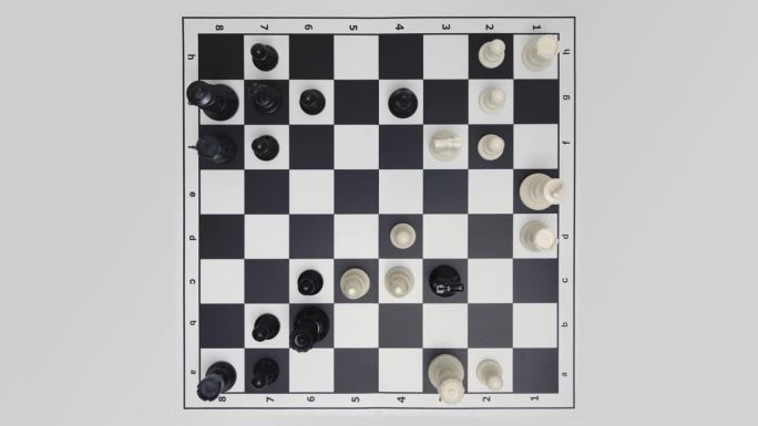 自上而下的视图停止运动延时下棋游戏在白色背景。移动的国际象棋人物