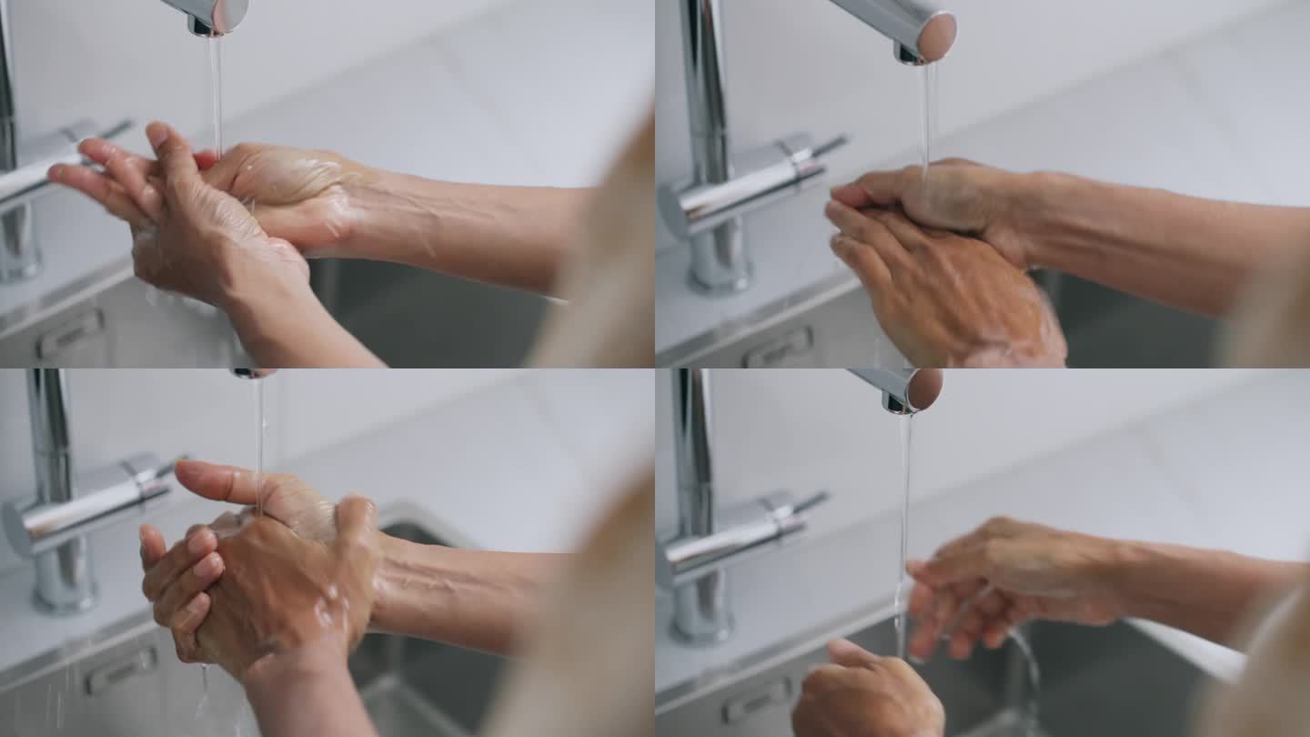 一个女人在厨房的水槽里洗手