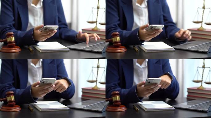 正义与法律概念。女法官在法庭上用木槌和数字智能手机对接键盘在木桌上工作。