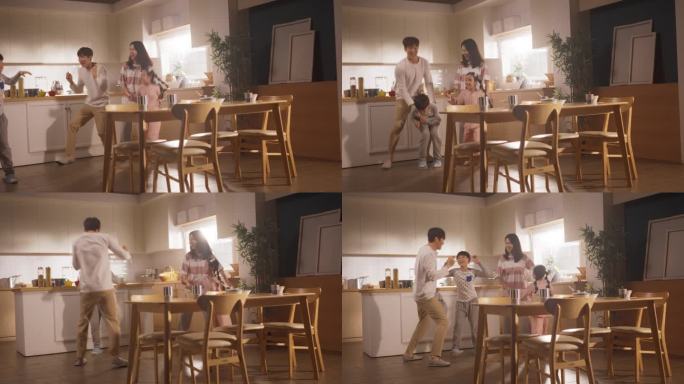 吃完营养早餐后，一家人在厨房里尽情跳舞。年轻的父母和他们可爱的孩子在早上听音乐玩得很开心