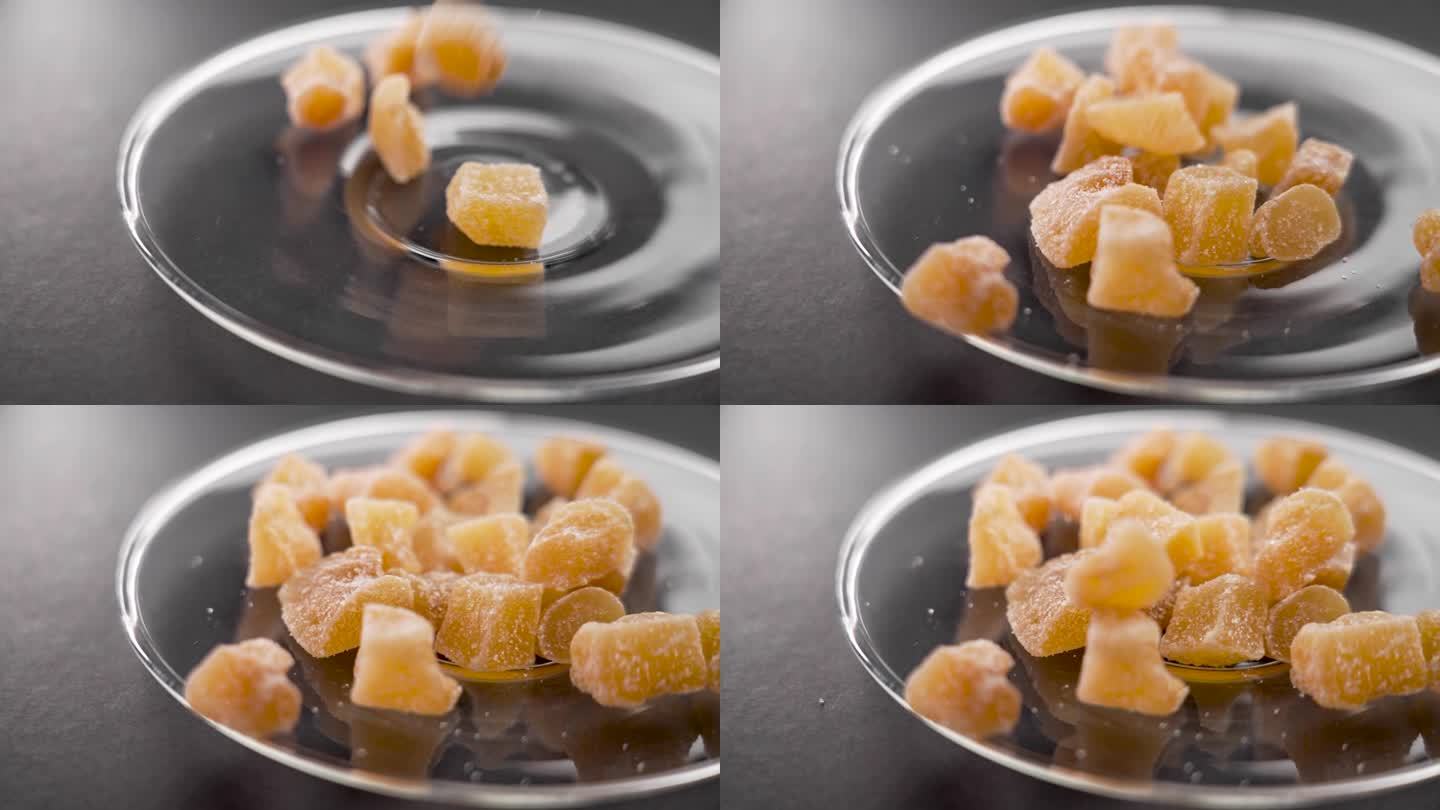 结晶的姜糖慢慢地落在玻璃碟子上。甜的健康食品