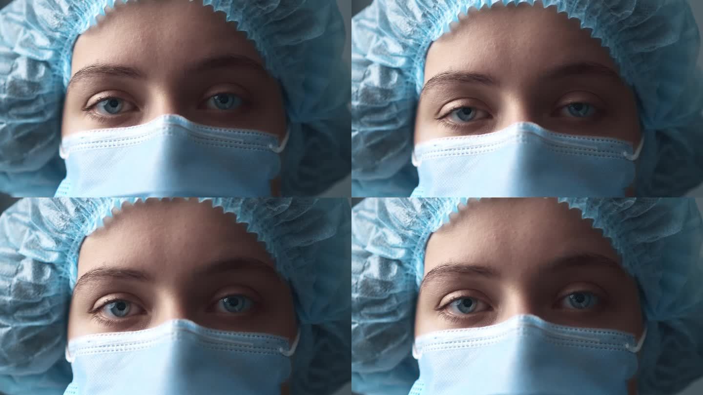 一个疲惫的医生的眼睛特写。一位戴着医用帽、戴着口罩、眼神忧伤的医生