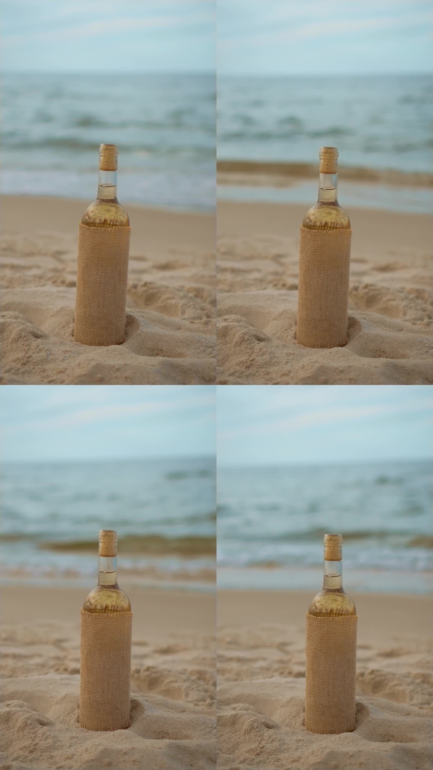 白葡萄酒在复古风格的瓶子在沙滩上的水波背景，垂直方向