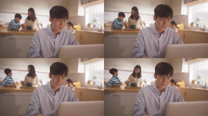 韩国家庭的延时摄影:年轻的父亲使用笔记本电脑远程工作，他的妻子和孩子在后台准备午餐。支持一个商人的家