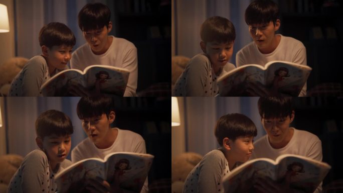 韩国父亲在睡觉前给他可爱的儿子读童话故事。年轻英俊的爸爸照顾他的儿子，晚上在家读故事书