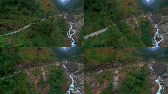 航拍图两辆车通过狭窄的砾石山路。公路旅行围绕喜马拉雅山脉。安纳普尔纳环行。尼泊尔的安全和道路概念。